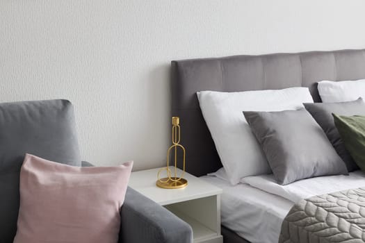 A modern bedroom that showcases a cozy atmosphere created with stylish decor, elegant furnishings, and soft textiles
