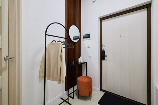 A modern entryway that features stylish decor alongside practical furniture designed for creating a welcoming space