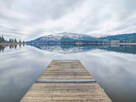 Looking out from the dock at the calm Rose Lake in north Idaho.
