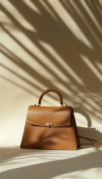 Luxurious mocha mousse designer handbag elegantly positioned on a textured beige backdrop. the lighting creates subtle shadows, the bag's craftsmanship and enhancing its rich color, perfect for high-end fashion presentations.