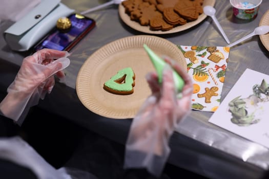 Decorating gingerbread cookies with colorful icing at a festive gathering is a truly memorable activity