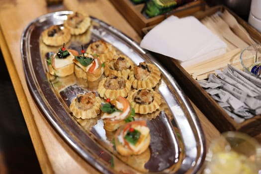 An exquisitely arranged and elegantly presented platter featuring a delightful assortment of gourmet hors doeuvres