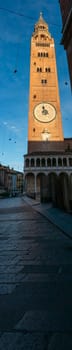 Cremona, Italy - November 27th 2024 Torrazzo bell tower of cremona cathedral rising above piazza del comune under blue sky