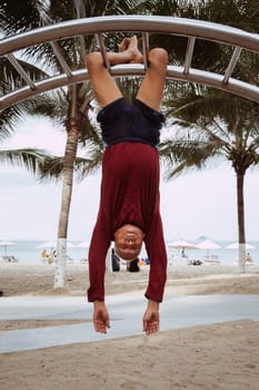 An elderly man is doing relaxing exercises outdoors. The concept of wellness, motivation to take care of health. Nha Trang, Vietnam - July 21, 2024