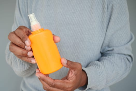 man holding a sunscreen cream .