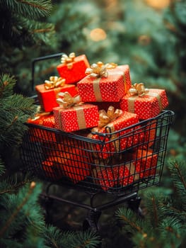 Red gift boxes, gold ribbons, nestled in a shopping cart amongst Christmas trees. A festive display.