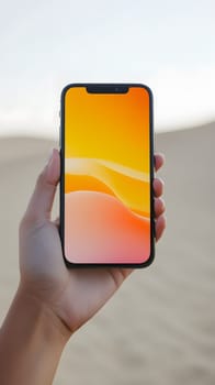 A hand holding a smartphone with a vibrant orange screen.