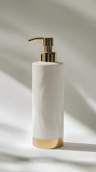 A sleek, modern pump bottle with a gold accent for liquid products.
