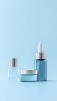 Three skincare containers on a light blue background.