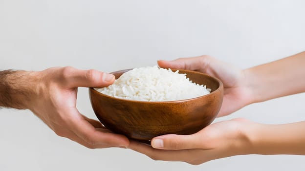 Two hands exchanging a bowl of rice, symbolizing sharing and generosity.