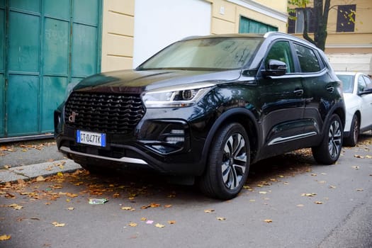 Cremona, Itally - October 6th 2024 A modern black dr 5.0 car parked elegantly in a bustling city street during autumn, exuding power and innovation with its sleek design and luxury appeal