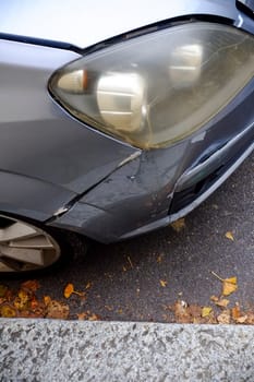 Cremona, Itally - October 6th 2024 Close-up photo of a silver opel corsa c parked on the street, showcasing the impact and scratches on the damaged bumper and headlight