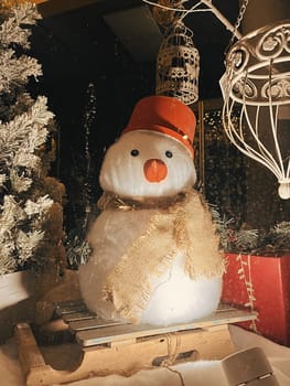 Aesthetic Warm Vintage Shop Window Photo with Snowman for Christmas. High quality photo