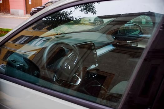 Cremona, Itally - October 6th 2024 Glimpse of sustainable transportation: modern electric car interior with a view of a building through the window, highlighting technological advancements