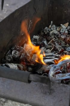 Burning coals in the old grill close up