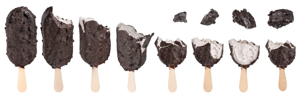 Ice cream with black chocolate icing on a white isolated background. Ice cream of different bitten pieces on white. Ice cream eating mockup. High quality photo