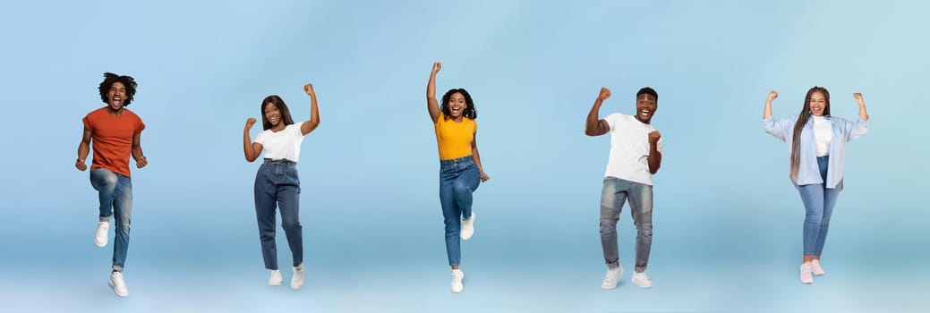 Smiling black young people jumping, making success sign, celebrating victory, enjoy spare time, have fun, isolated on blue studio background, panorama. Winners, free time and lifestyle