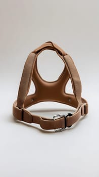 A brown pet harness designed for comfort and safety.