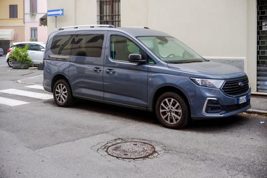 Cremona, Itally - October 6th 2024 New ford tourneo connect titanium 1.5 ecoblue parked on the side of the street with a pedestrian crossing in the background