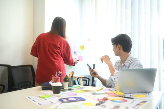 Creative team discussing app development ideas during meeting.