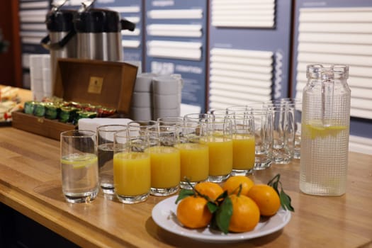 This is a vibrant and colorful display of drinks alongside fresh fruit, perfect for events or casual gatherings