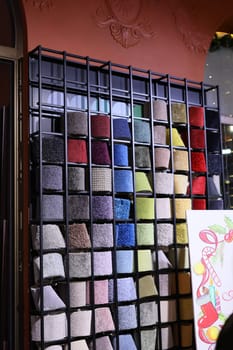 A vibrant showcase of a variety of beautifully textured fabrics arranged in a stylish, artistic display