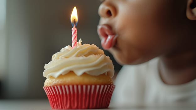 A child blowing out candle on frosted cupcake, celebrating special moment