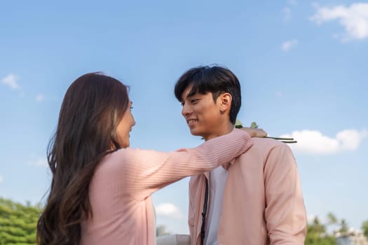 A couple shares a tender moment embodying love and romance in a picturesque outdoor setting.