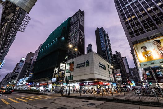 HONG KONG, CHINA - SEPTEMBER 28, 2024: Busy Nathan Rd at night with famous signage, architecture and traffic in Mongkok on Kowloon in Hong Kong