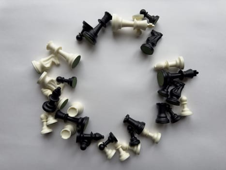 Circular arrangement of chess pieces on white background.