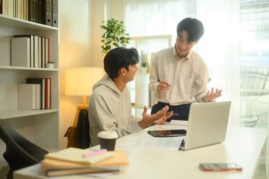 Smiling tutor guides a student through a lesson during a home tutoring session.