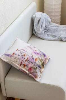 Decorative cushion and plaid on the sofa