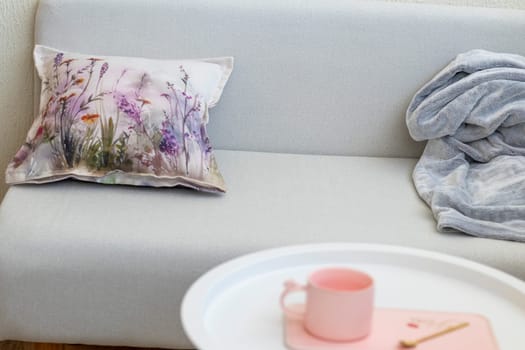 Decorative cushion and plaid on the sofa