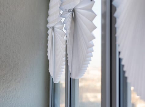 Paper blinds on the window in the balcony of the apartment