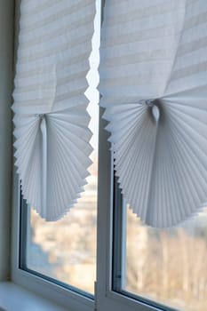 Paper blinds on the window in the balcony of the apartment