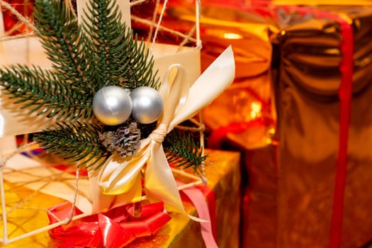 Ornate decorations feature silver baubles and a green wreath, enhancing the vibrant holiday atmosphere filled with beautifully wrapped gifts and ribbons under warm lighting.