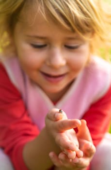 Child playing with ladybug. Selective focus. Kid.
