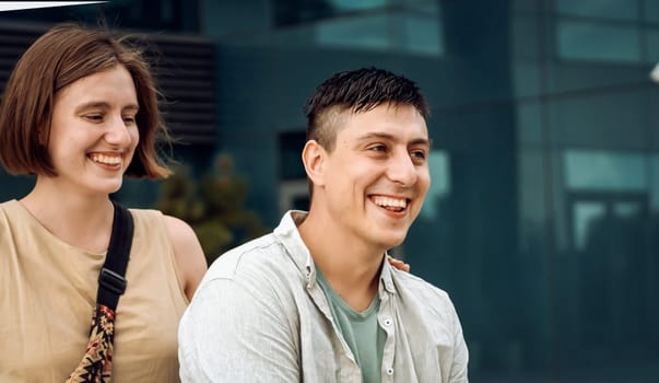 Two people having fun together, faces of happy smiling young man and girl in casual clothes on a walk, couple in love or friends lead an active lifestyle.