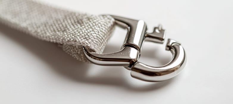 High-quality metal clasp of a lanyard displayed against a minimalist white background. the image sturdy, sleek design, emphasizing durability and craftsmanship, ideal for use in professional presentations and product showcases.