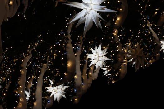 A stunning display of dazzling winter lights and arranged star decorations, creating a festive atmosphere