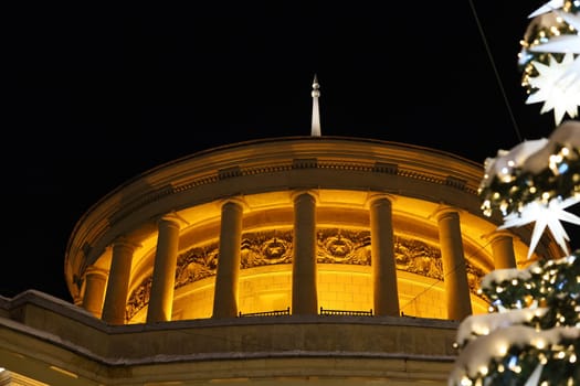 A stunningly illuminated dome showcasing classical architecture set against a starry night sky that captivates