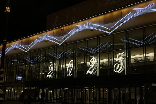 A vibrant night scene showcasing a breathtaking light display, celebrating the arrival of the year 2025