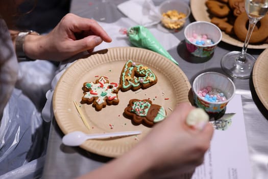 A festive holiday cookie decorating scene with beautifully decorated cookies and an array of toppings