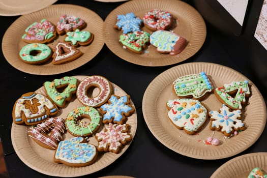 A variety of beautifully decorated holiday cookies arranged on plates, perfect for festive gatherings.