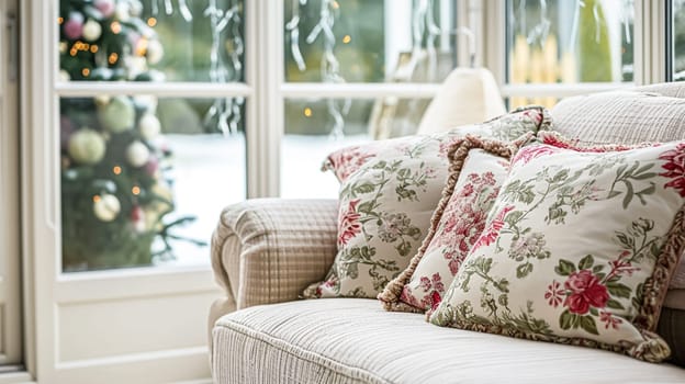 Colorful pillows on sofa against glass wall of window in a winter garden or conservatory. Interior textile concept. High quality photo
