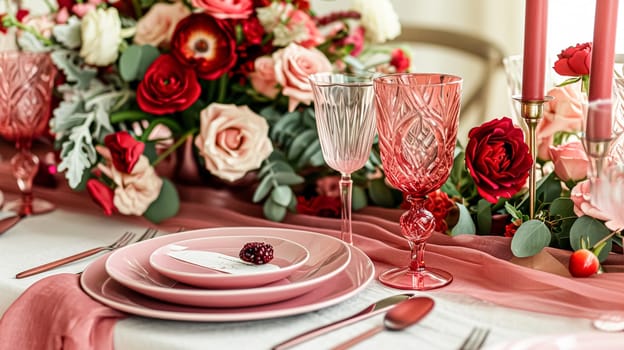 Festive table setting with candles and arrangement of beautiful red flowers. Holiday concept. High quality photo