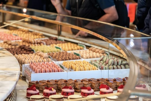 Various assortment of desserts confectionery on the counter in a bakery. Paris, France