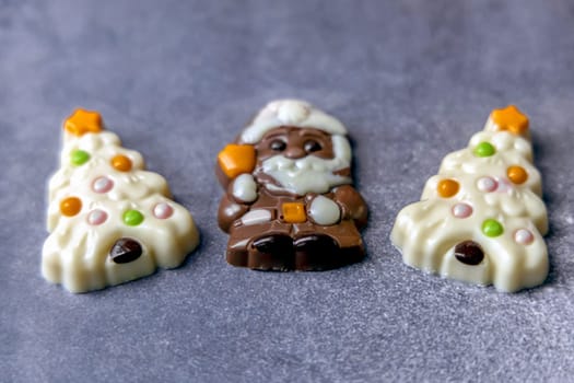 Christmas chocolates. Chocolate Christmas trees and Santa Claus. High quality photo