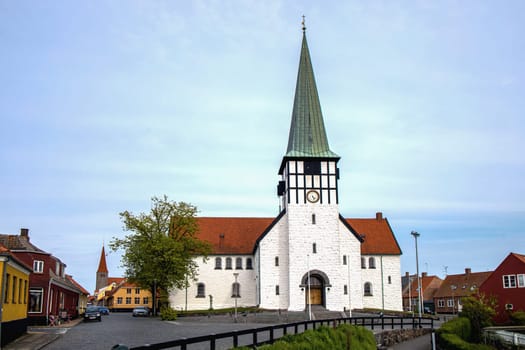 Ancient street and the white church of the city of Ronne, Bornholm Island, Denmark - November 20, 2024