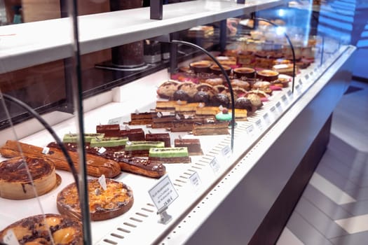 Various assortment of desserts confectionery on the counter in a bakery. Paris, France - Novenber 15, 2024